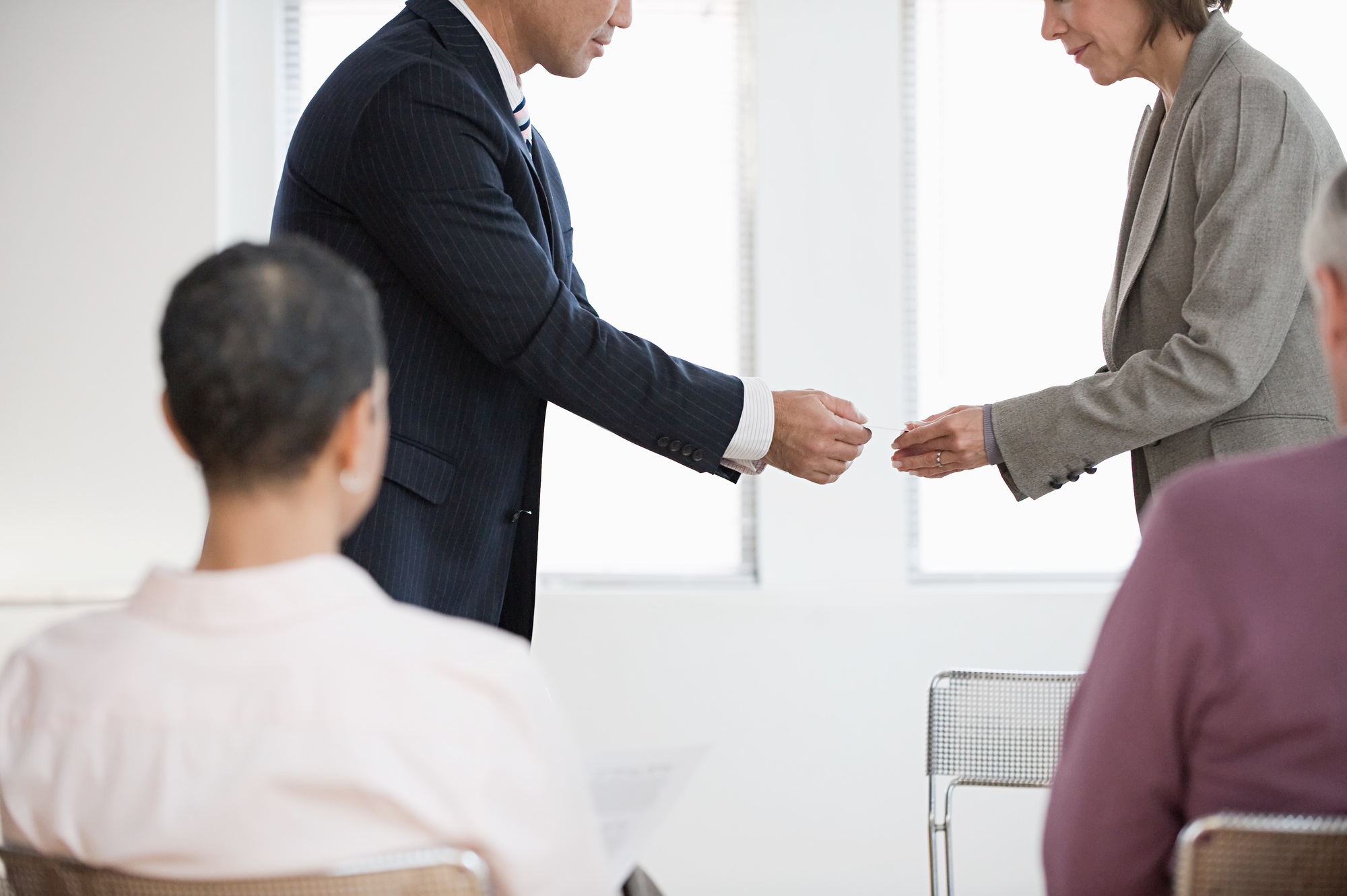 Businesspeople exchanging business cards